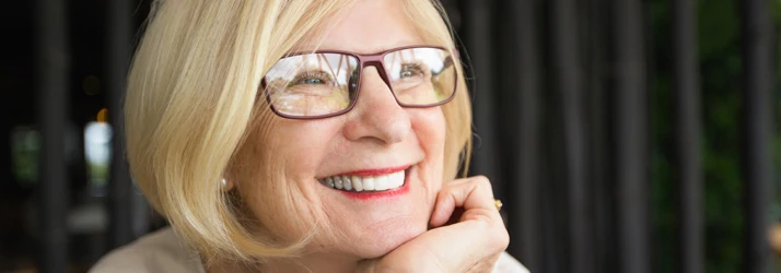 Periodontist Portland ME Closeup Happy Attractive Senior Woman in a Cafe Smiling Bridges Focused Closeup Happy Attractive Senior Woman in a Cafe Smiling